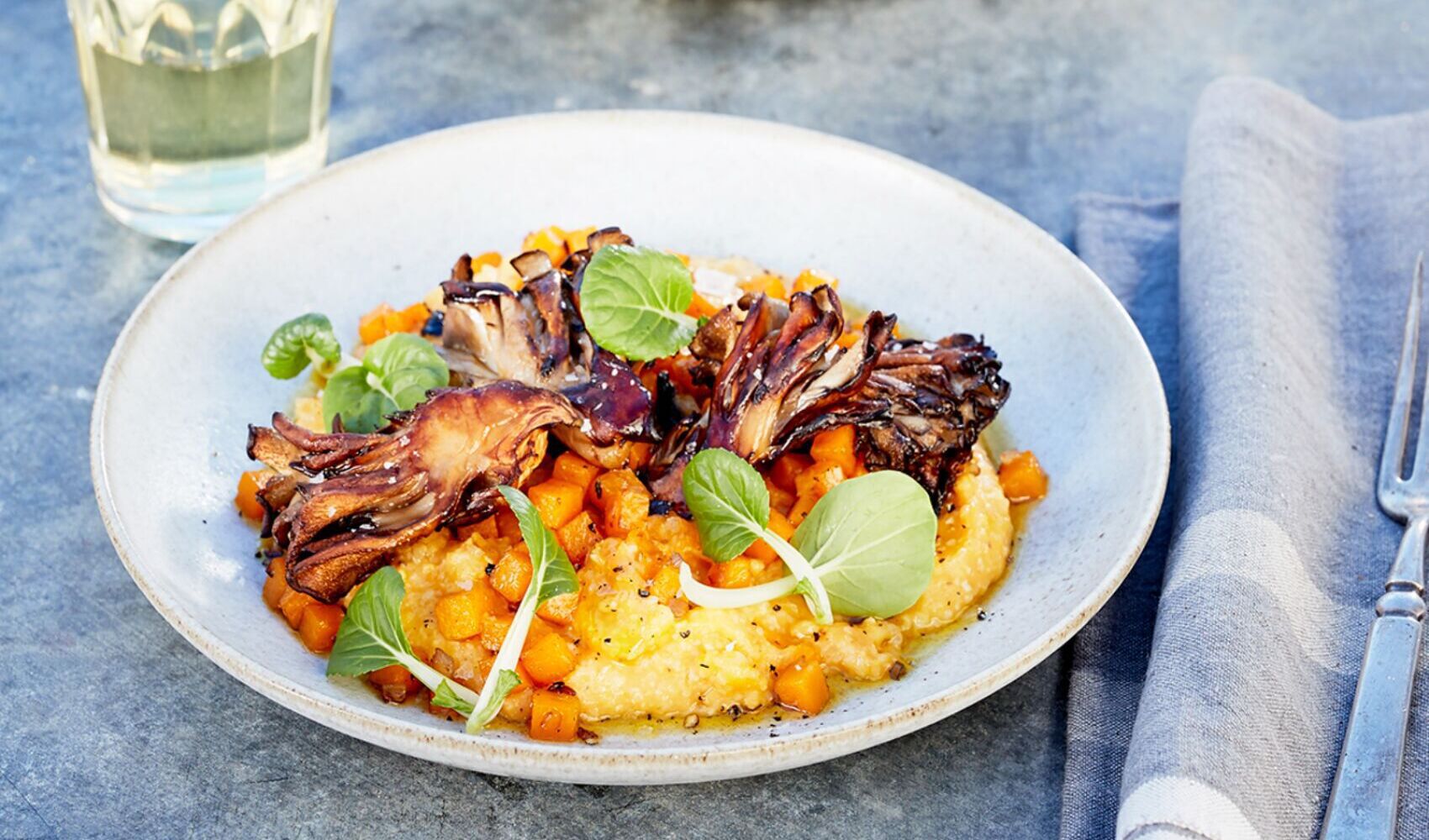 Two plates of Pumpkin Grits with Maitake Mushrooms